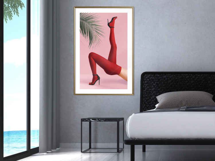Plakat Czerwone rajstopy - kobiecie nogi, szpilki i liść palmy na różowym tle 144125 additionalImage 18