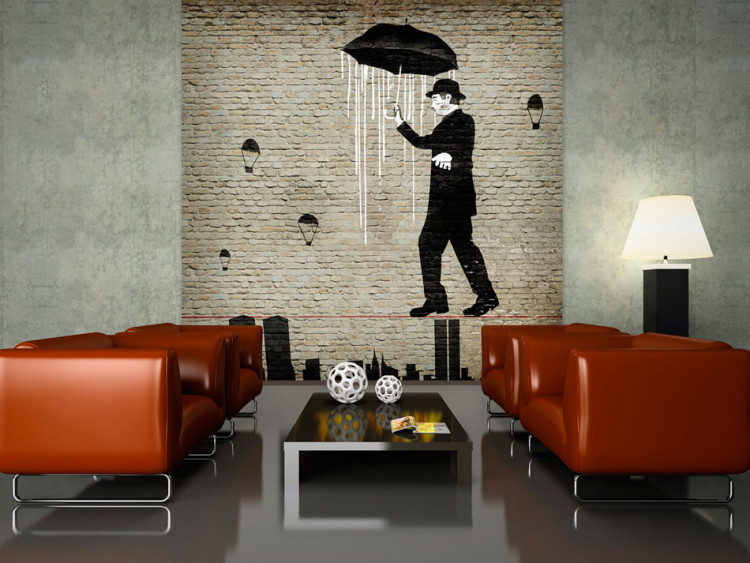 Fototapeta Charlie Chaplin - mural z sylwetką mężczyzny z parasolem na linie 60748